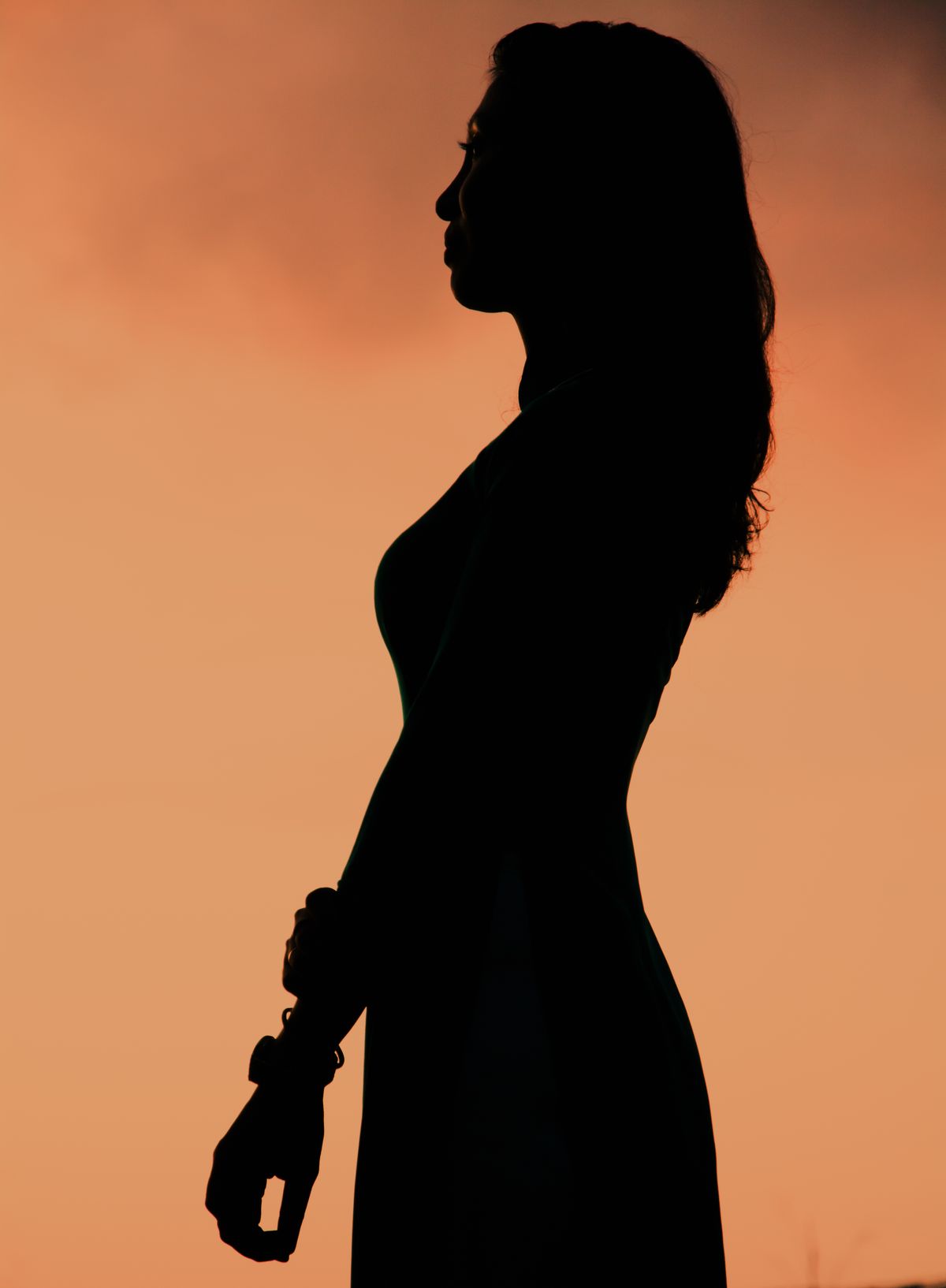 Stock stand-in: a silhouetted profile bathed in warm orange light