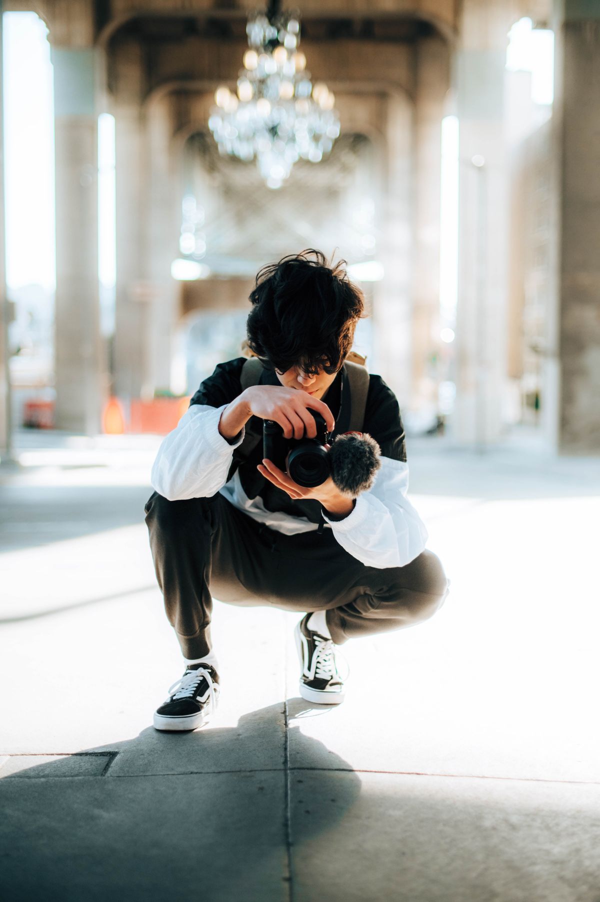 Stock stand-in: a photographer raising a camera to take a shot